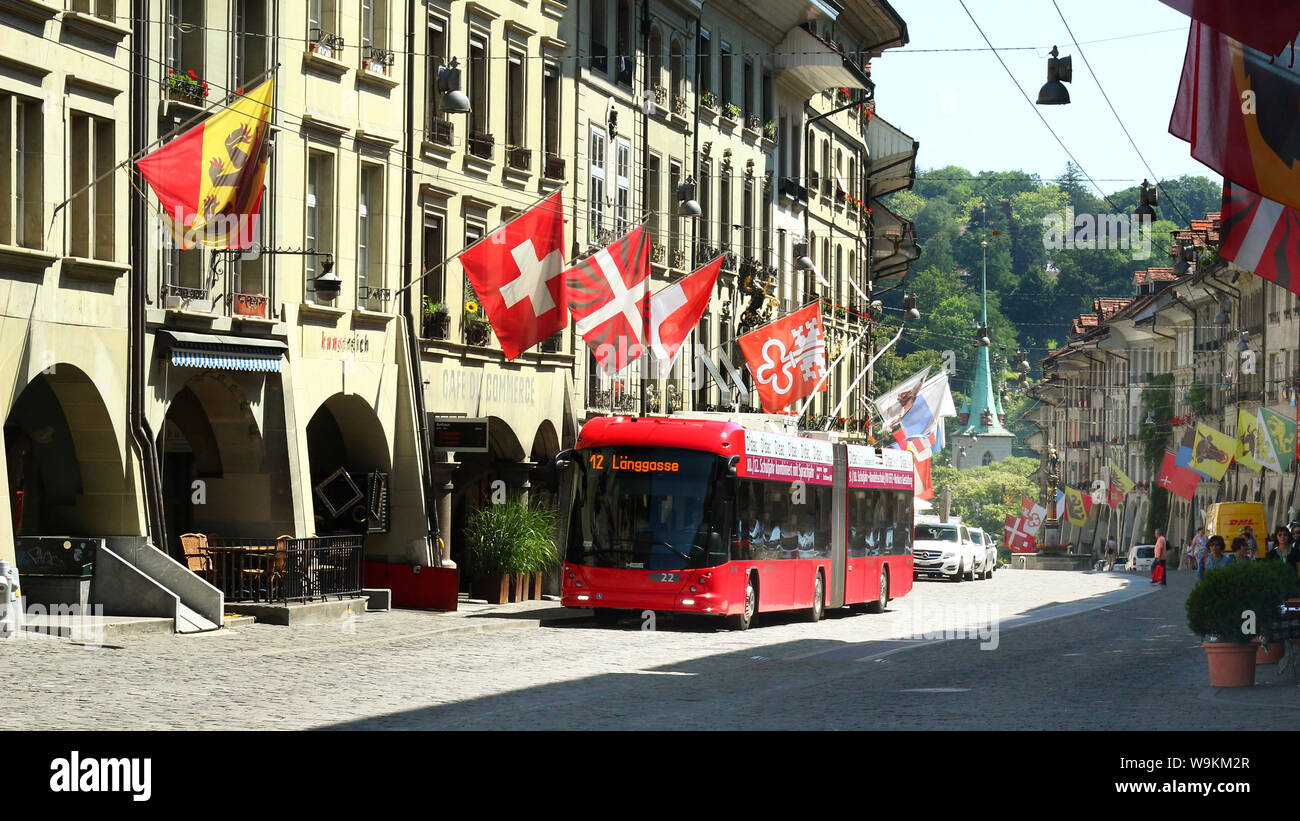 Bern, Switzerland - July 23, 2019: A red bus drives in the ancient and historic center, the street is Gerechtigkeitsgasse Stock Photo