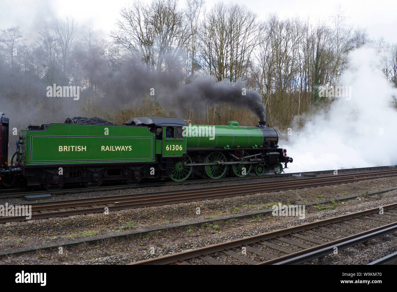 B1 Class loco 61306 Mayflower lets of steam heading off from Winchfield ...