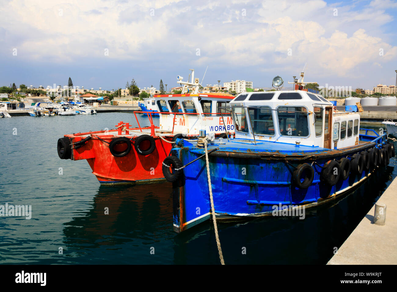 Red and blue work boats moored alongside the quay, Zygi harbour, Cyprus October 2018 Stock Photo