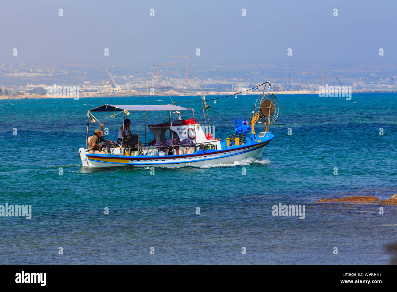 Traditional Cypriot fishng boat and crew, heading out to sea from Potamos Creek, Liopetri, Cyprus October 2018 Stock Photo