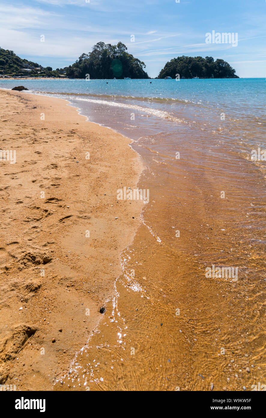 Orange sand and blue water at Kaiteriteri Beach on the South Island of New Zealand Stock Photo