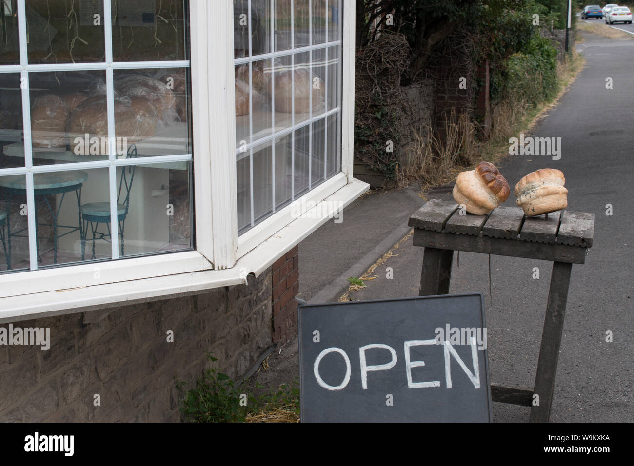 Bread shop artisan bakery loafs of bread on table outside small local shops advertising that they are open for business Wiltshire UK 2019 HOMER SYKES Stock Photo