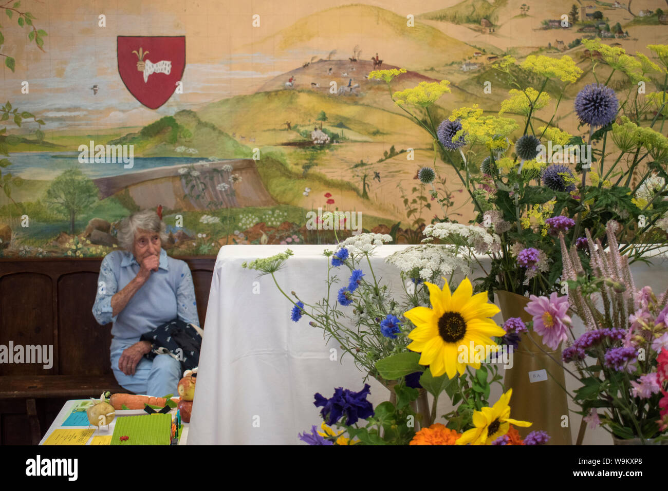 Getting old alone, sing elderly woman at the village produce and flower ...