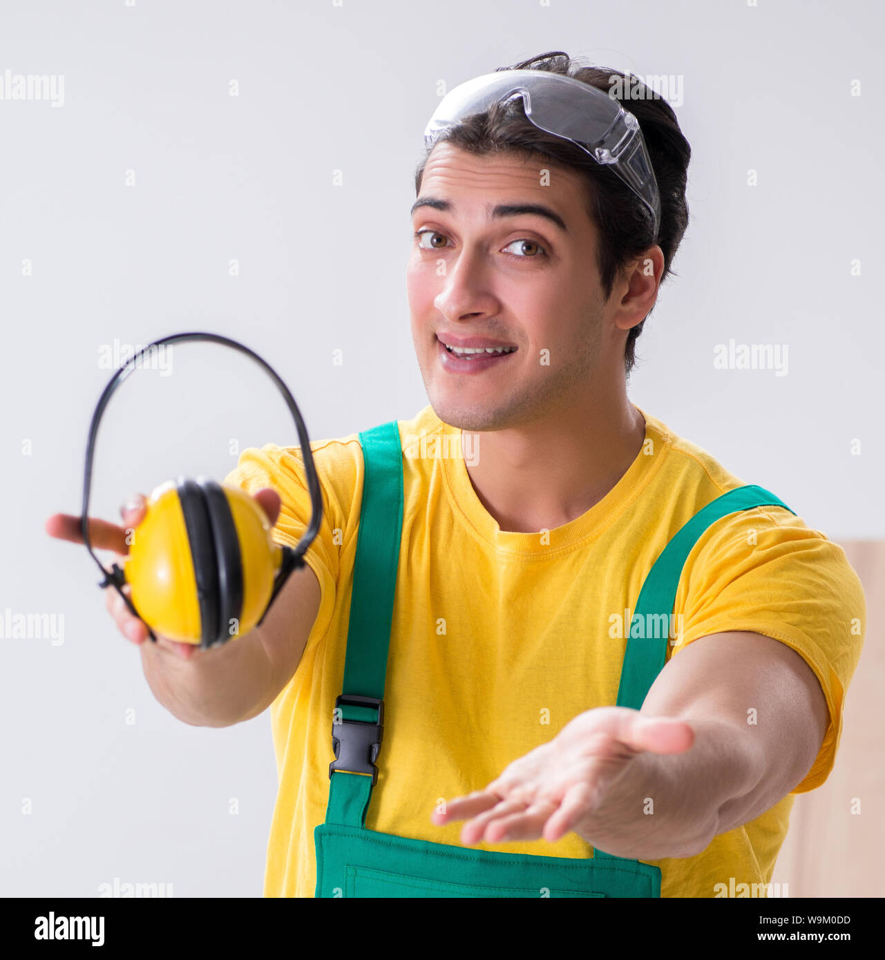 Worker showing the importnace of wearing noise cancelling headphones