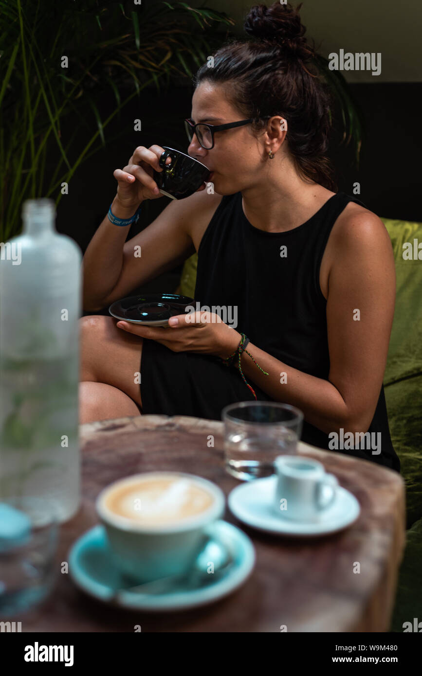 Girl enjoying a cup coffee at a coffee shop Stock Photo