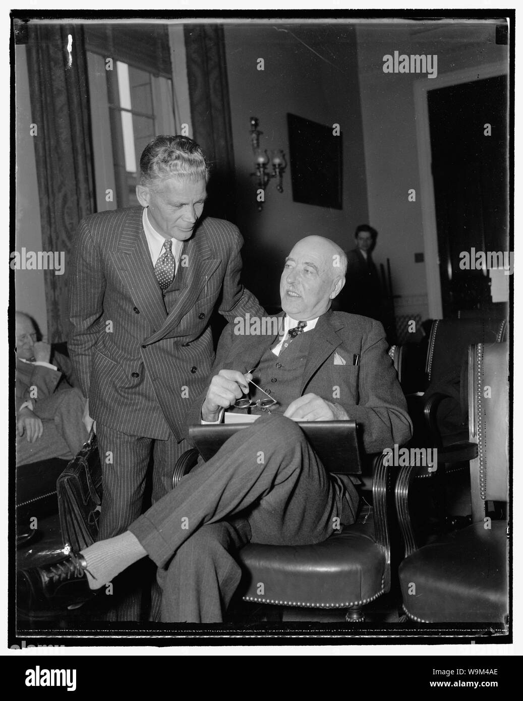 Appear before house rivers and harbors committee. Washington, D.C., Nov. 23. Stuart Chase, (left) New York economist, and L.C. Sabine, of Cleveland, Vice-President of the Lake Carriers Association, were the first witnesses called today as the House Rivers and Harbors Committee began hearings on a bill to create seven Regional Planning Authorities. Chase told the committee that free competition no longer is operating over a broad part of the economic front. He predicted further dislocation of man and his natural resources unless there is planned economics and conservation. 11/23/37 Stock Photo