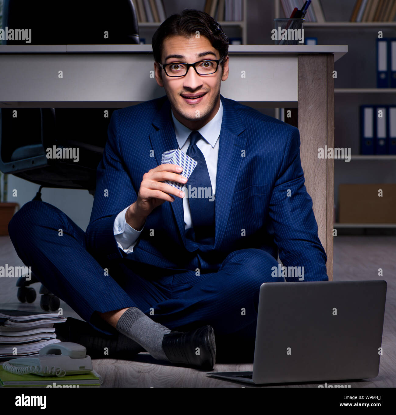 The businessman working overtime long hours late in office Stock Photo