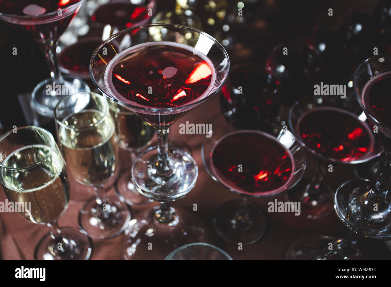 Many glasses of alcoholic drinks, champagne and cocktails on the festive table Stock Photo