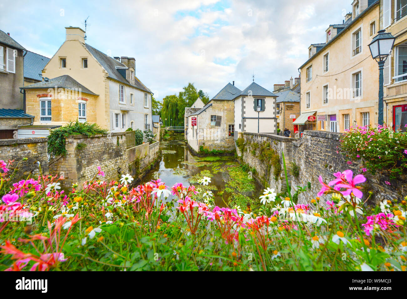 The picturesque French town of Bayeux France near the coast of Normandy with it's medieval houses overlooking the River Aure on an overcast day Stock Photo