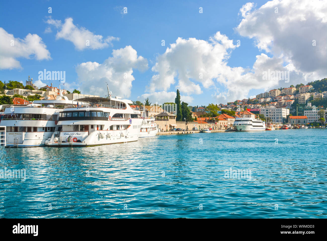 Boats line up at the pier and boardwalk in the harbor of Dubrovnik, on the Dalmatian coast of Croatia. Stock Photo