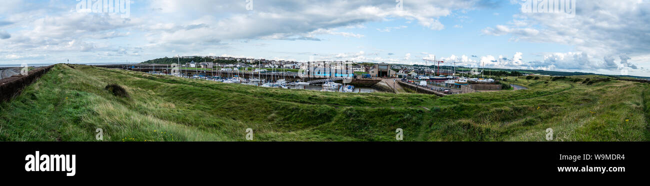 Maryport harbour seen from beach wall Stock Photo