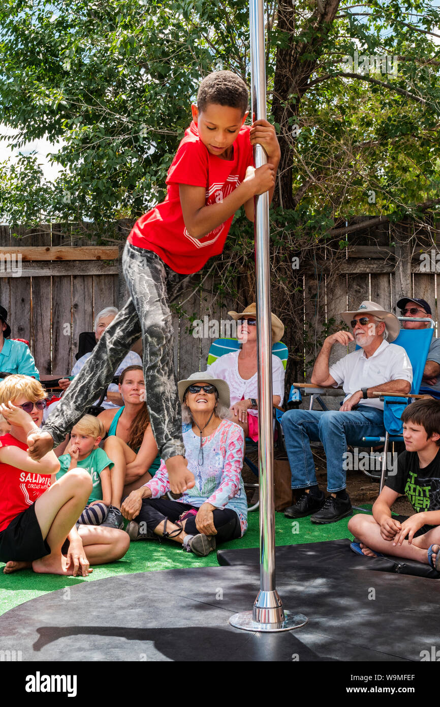 African American boy performing pole act; Salida Circus summer camp finale; Salida; Colorado; USA Stock Photo