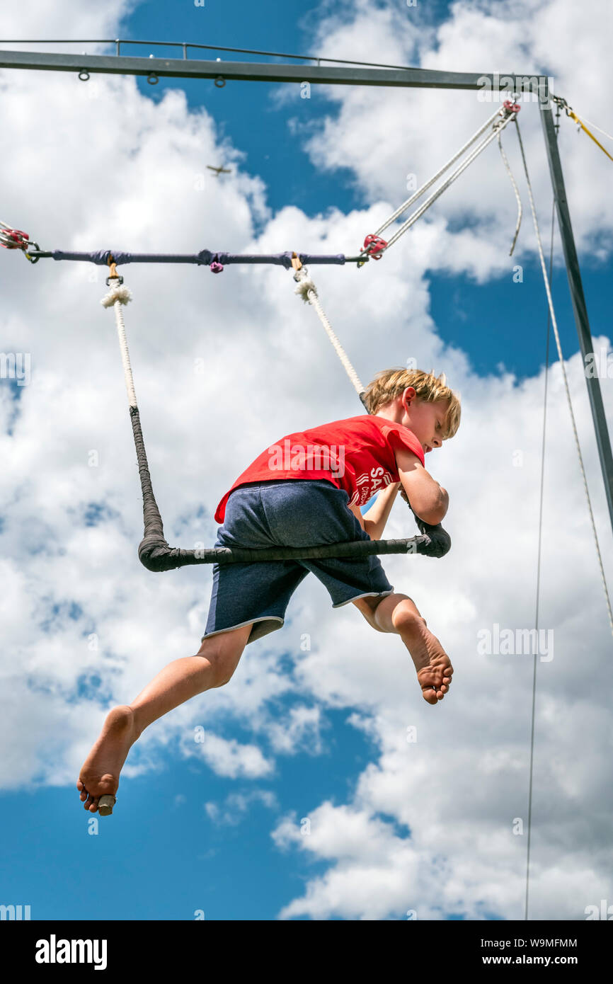 Young boy performing on trapeze; Salida Circus summer camp finale; Salida; Colorado; USA Stock Photo