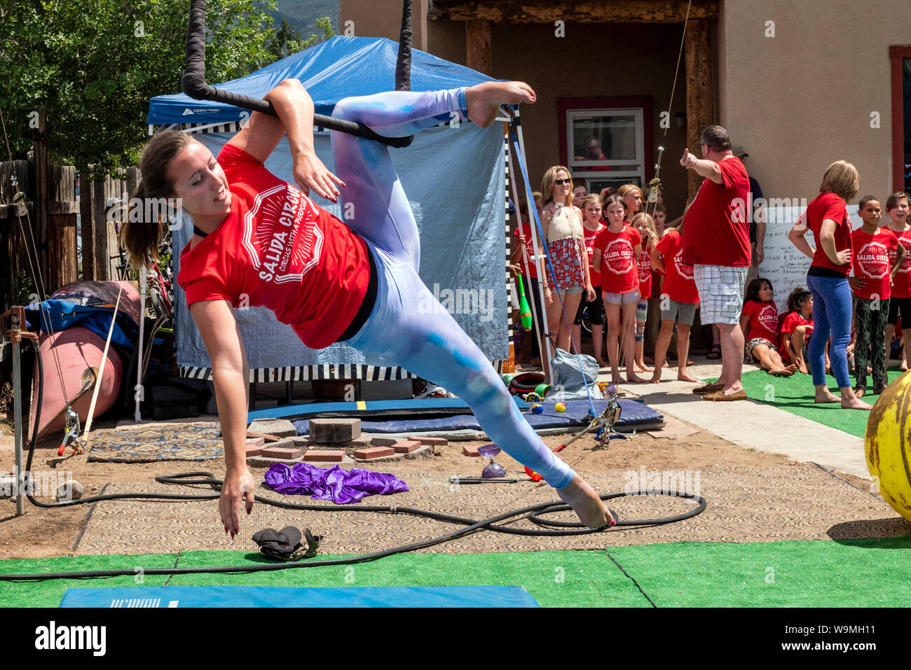 Young woman performing on trapeze; Salida Circus summer camp finale; Salida; Colorado; USA Stock Photo