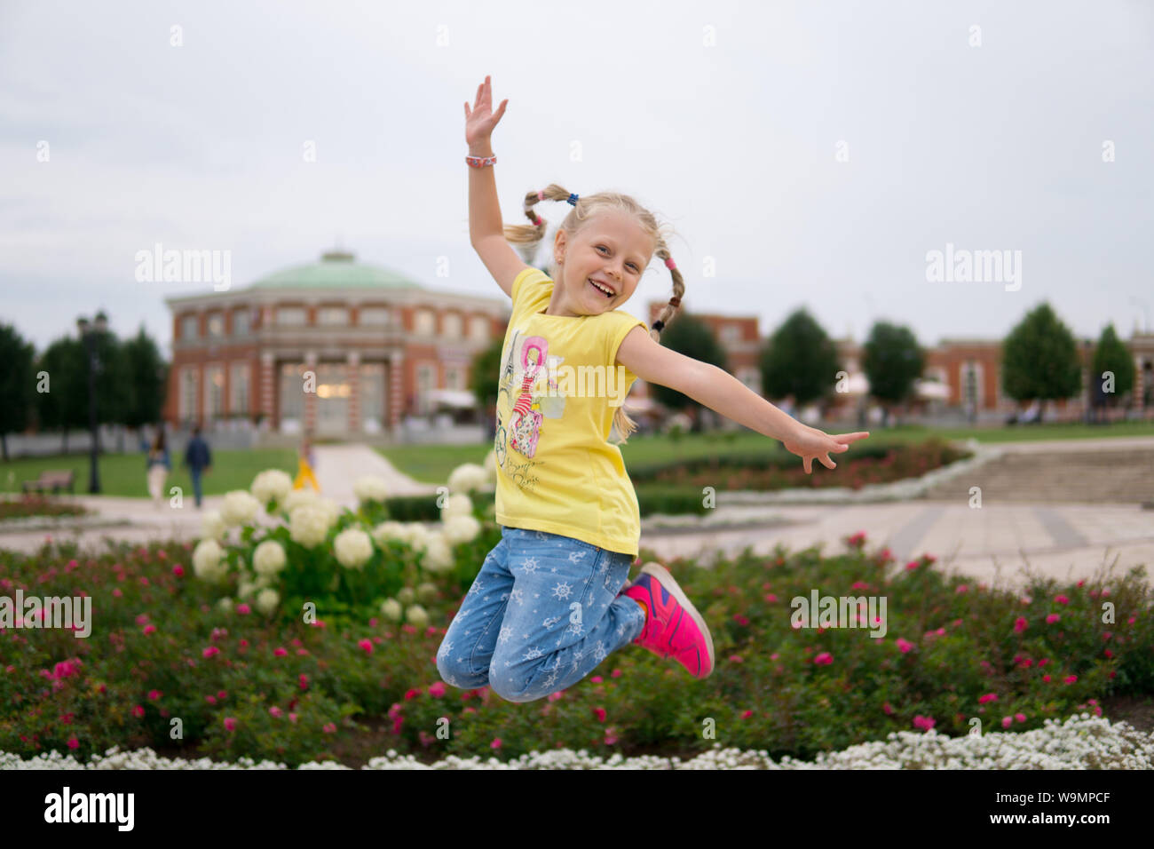 Happy young woman jumping in air in hi-res stock photography and images ...