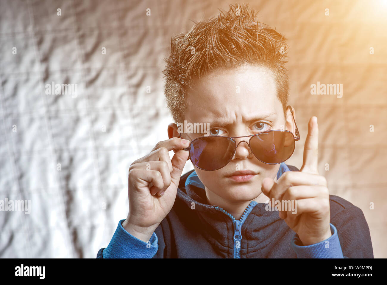 the boy raised his finger reproachfully and raised his eyebrows to his