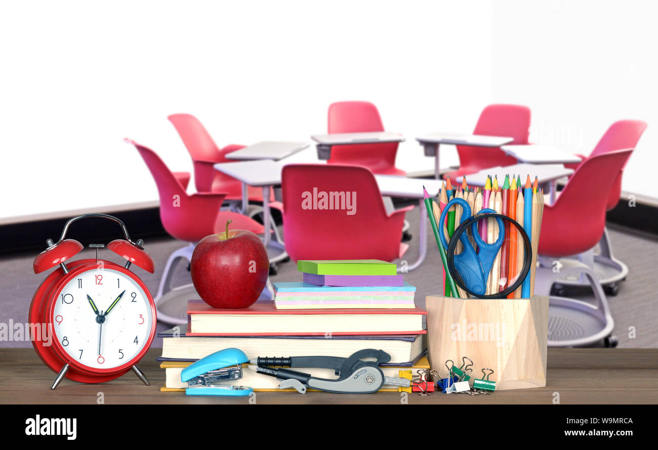 chair and table form in circle in empty classroom with book for