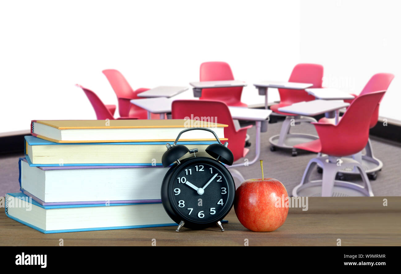 chair and table form in circle in empty classroom with book for