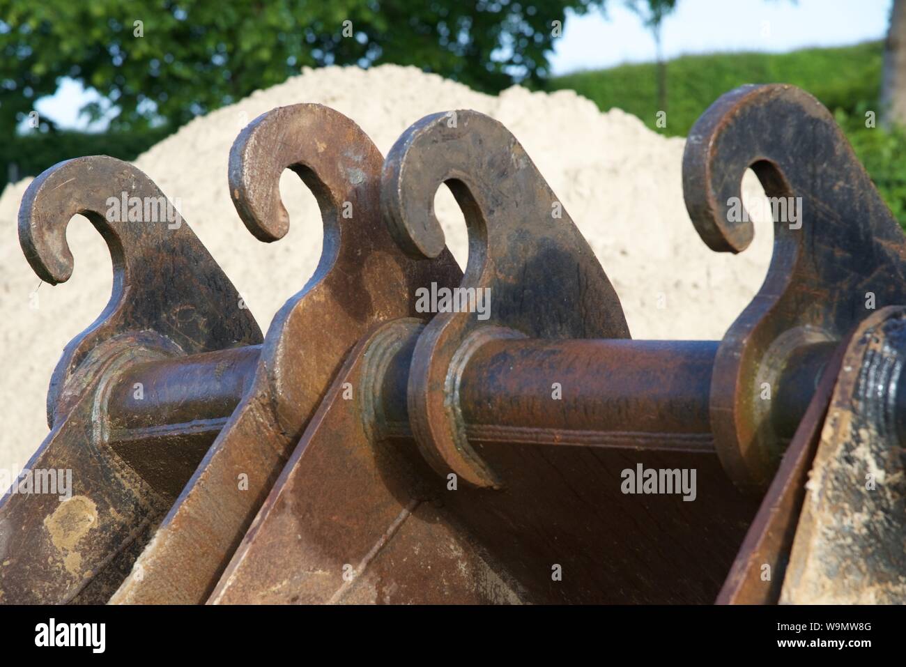 different sizes of excavator buckets and are lined up ready for use on ...