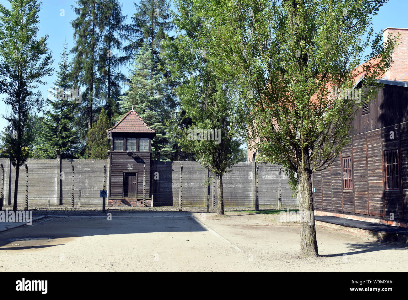 A general street view showing a watch tower and electrified fences at the Concentration Camp  in Poland Stock Photo