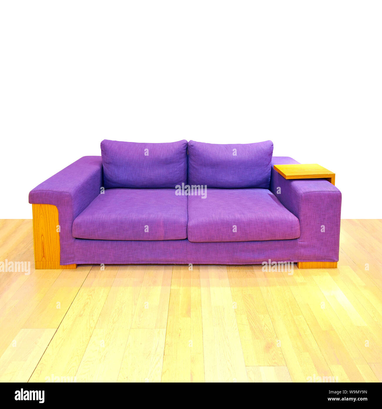 Big purple sofa in living room with hardwood floor Stock Photo Alamy