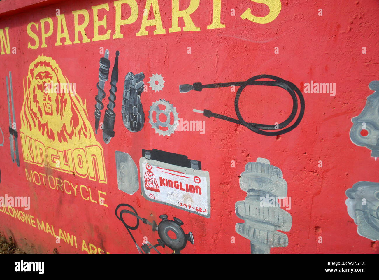 Motorcycle spare parts painted advert on wall in Lilongwe, Malawi