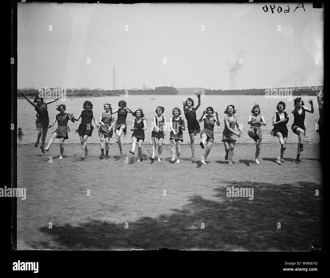 Bathing beauties dancing on Washington, D.C. beach; English Bathing