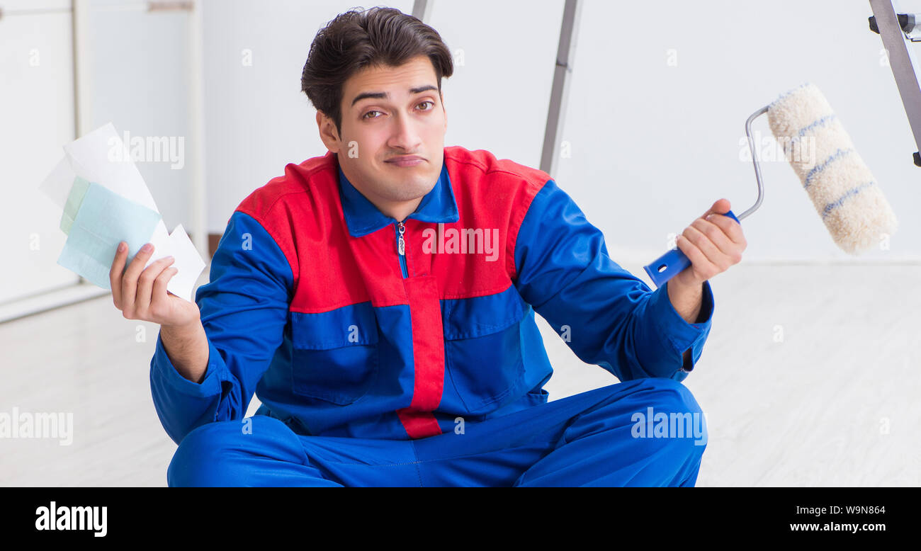 The young painter trying to match colours for painting job Stock Photo