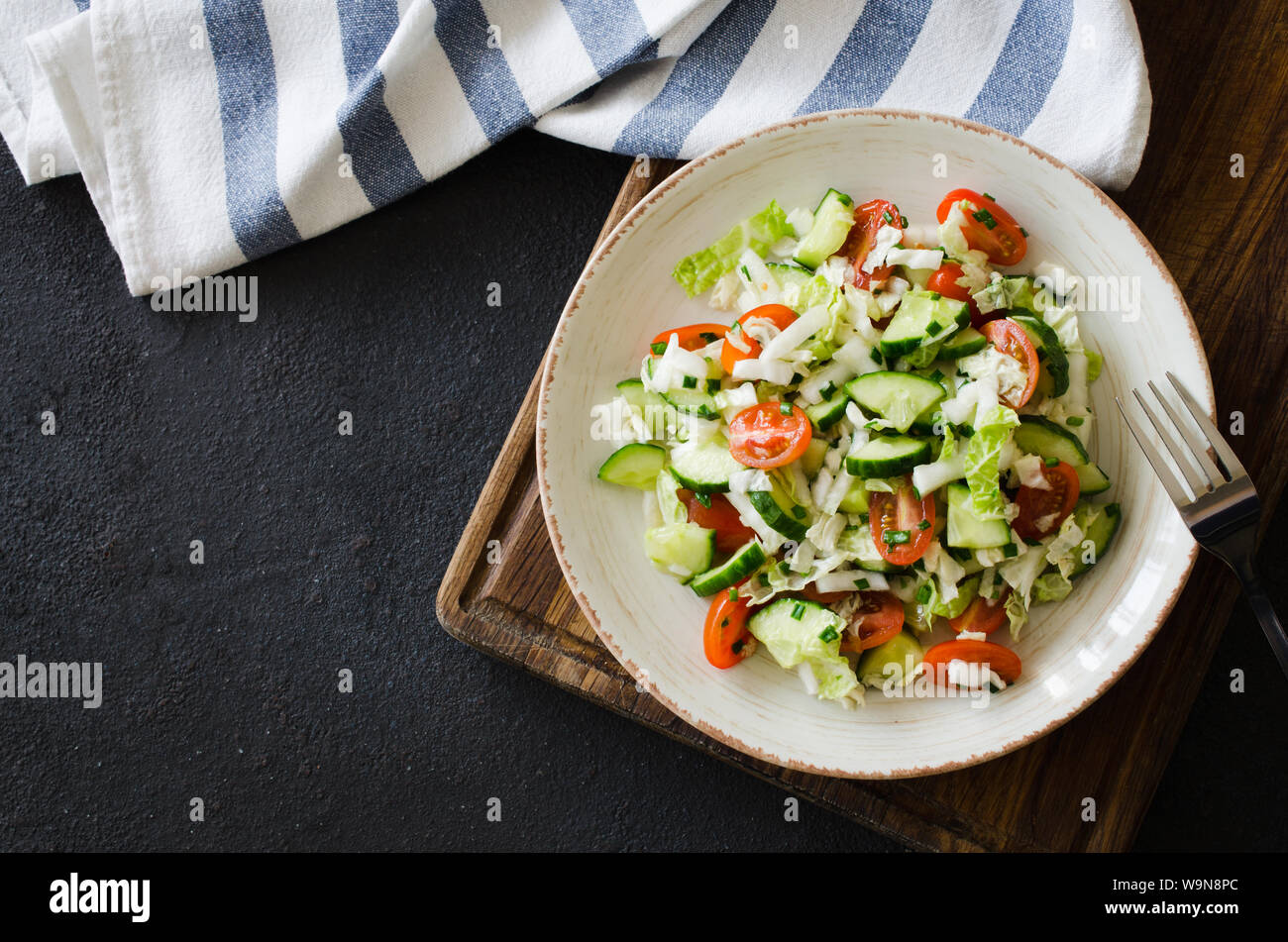 Healthy vegetable salad of fresh tomato, cucumber, peking cabbage and