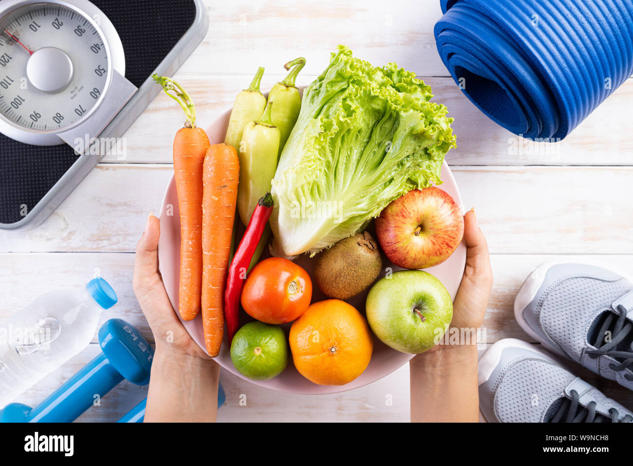 Healthy lifestyle, food and sport concept. Top view of woman hand