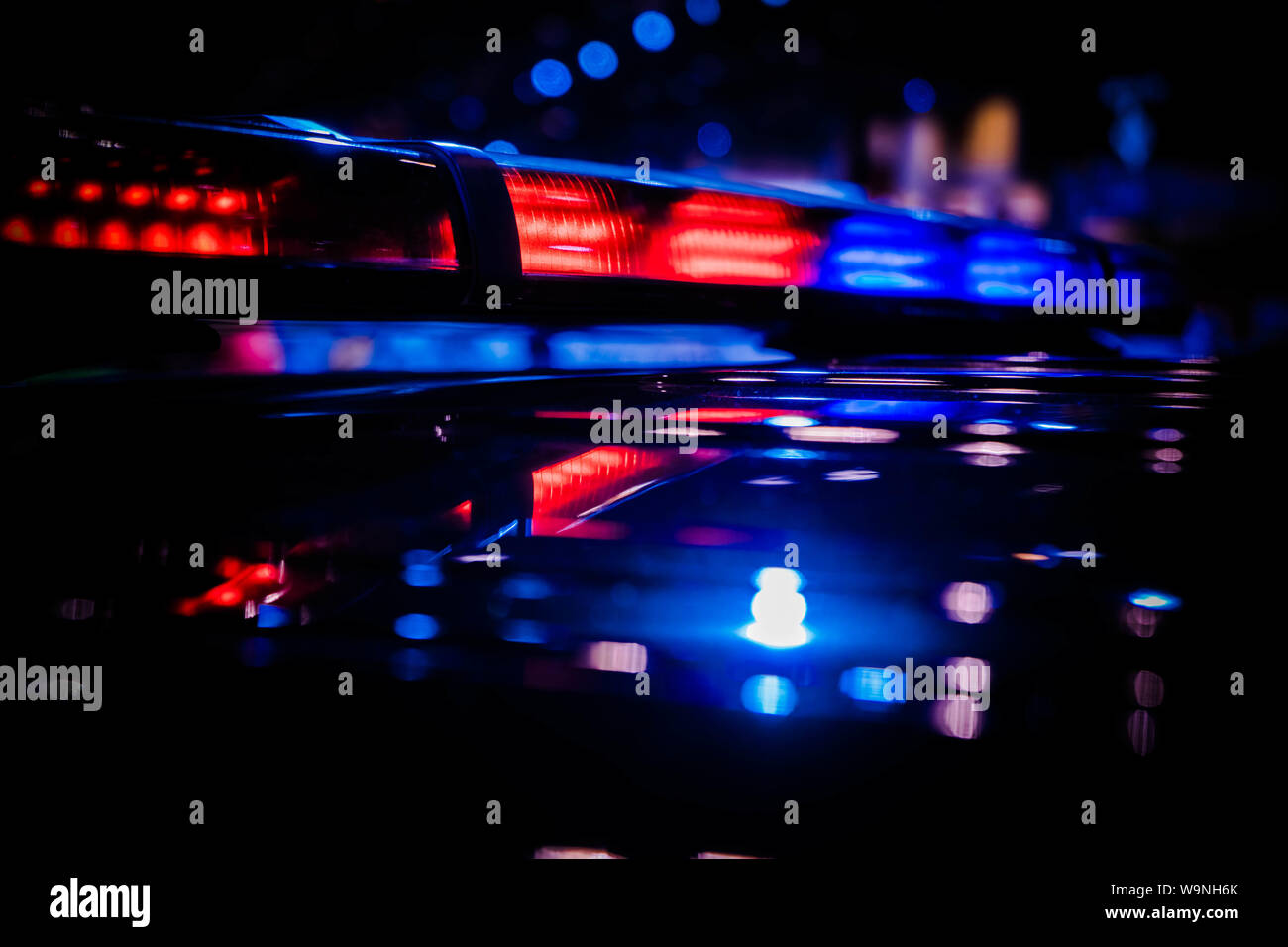 Emergency warning red and blue roof mounted police LED blinker light bar  turned on Stock Photo - Alamy
