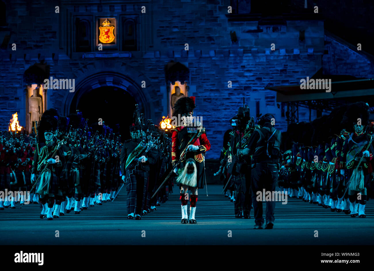 Edinburgh, Scotland, UK. 14th Aug 2019. Royal Edinburgh Military Tattoo 2019 Kaleidoscope on Castle Esplanade in its 69th show inspired by the optical instrument by Scottish scientist Sir David Brewster and Sir Isaac Newton's seven colours. It features traditional Massed Pipes and Drums. A marching band playing bagpipes in Scottish military uniform with kilts and puttees Stock Photo