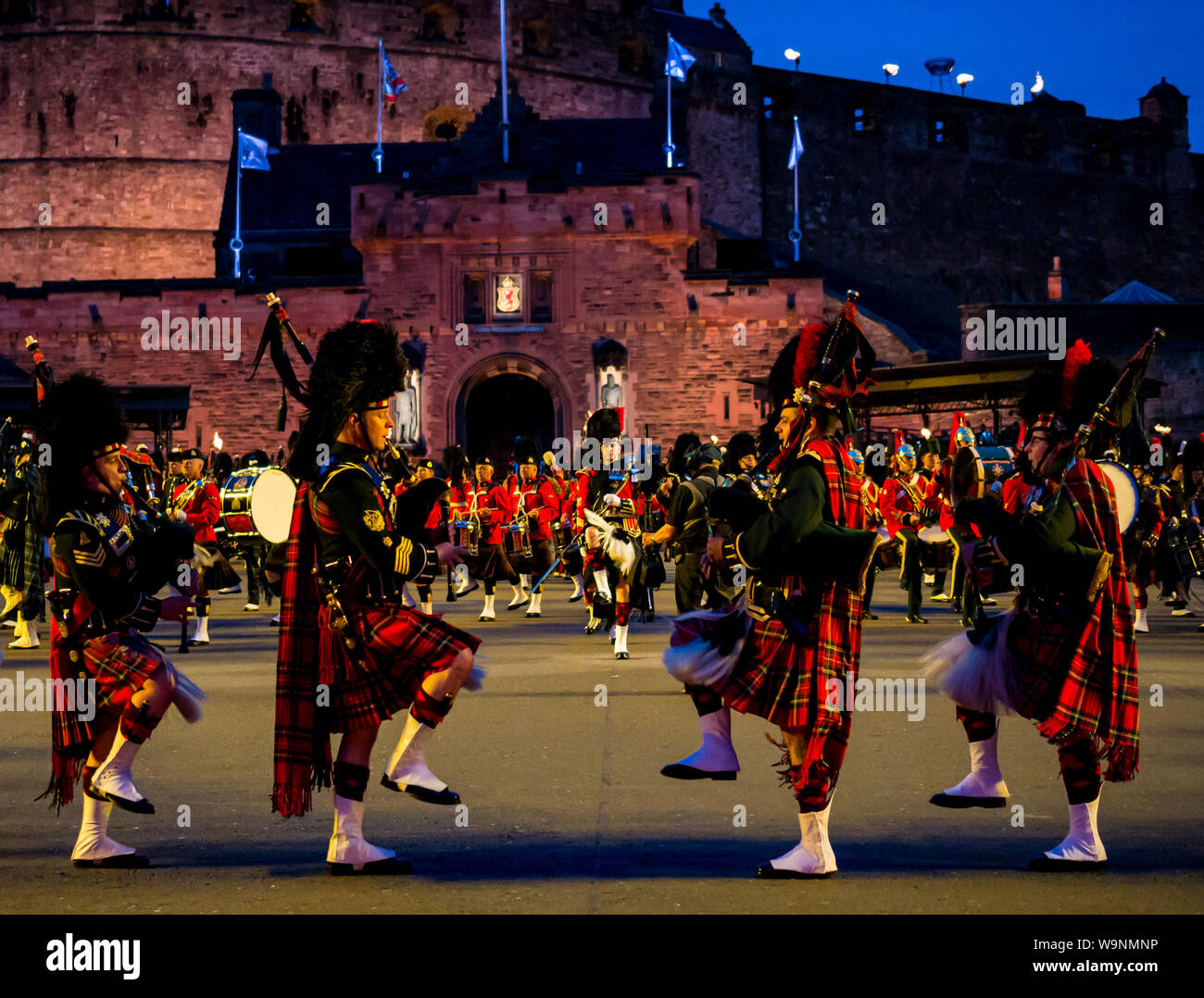 Edinburgh, Scotland, UK. 14th Aug 2019. Royal Edinburgh Military Tattoo 2019 Kaleidoscope on Castle Esplanade in its 69th show inspired by the optical instrument by Scottish scientist Sir David Brewster and Sir Isaac Newton's seven colours. It features traditional Massed Pipes and Drums. A marching band playing bagpipes in Scottish military uniform with kilts and puttees Stock Photo
