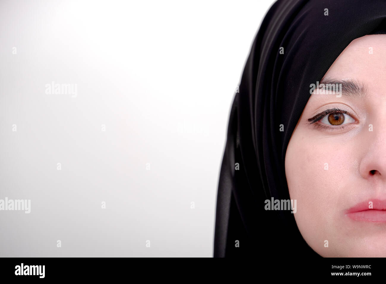 Half portrait of hijab muslim woman, closeup of muslim girl and she wearing black scarf or veil Stock Photo