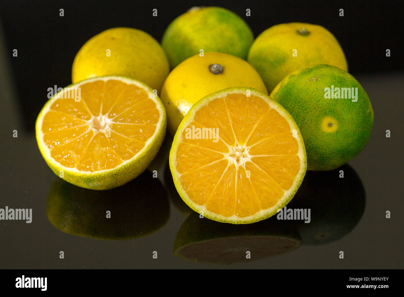 Fresh juicy clementine mandarins isolated on black Stock Photo Alamy