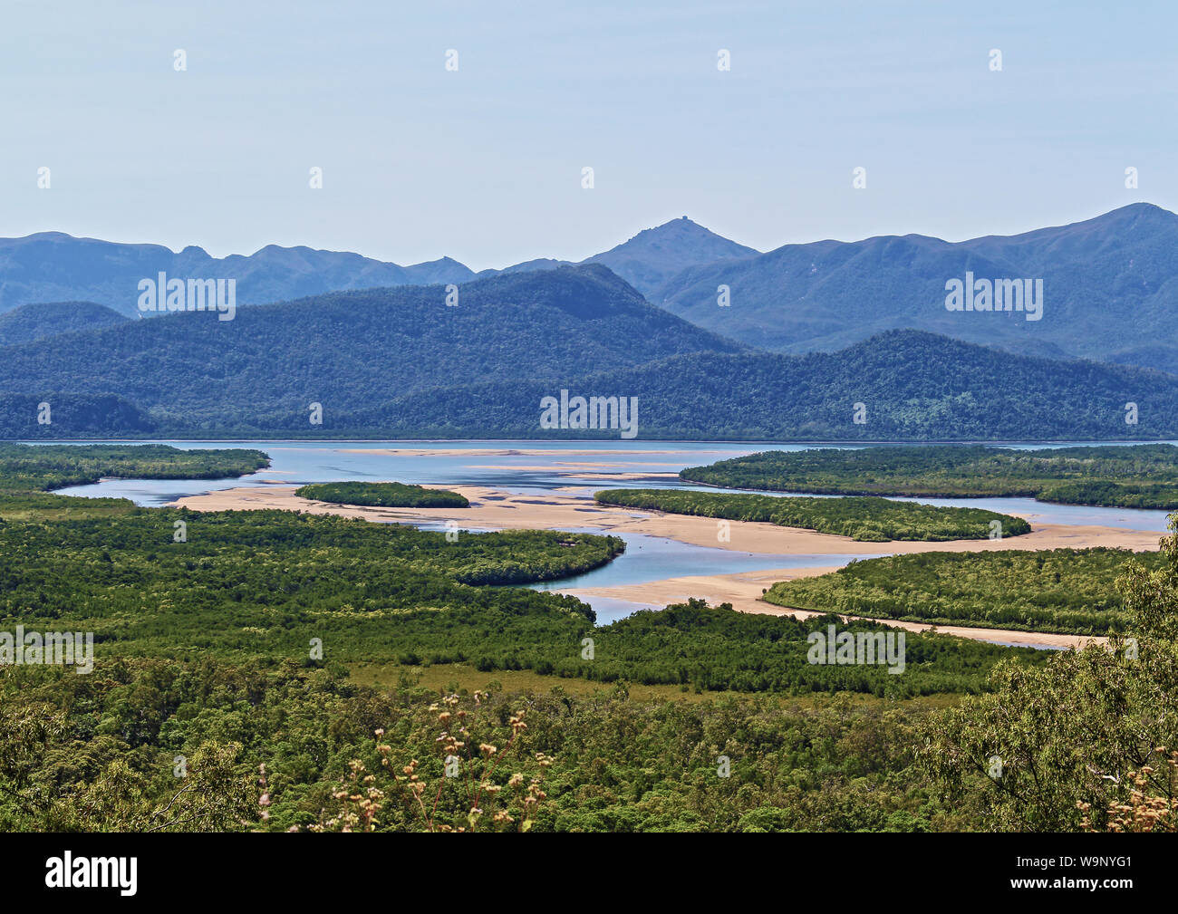 Panjoo Lookout on Bruce Highway through the Cardwell Ranges offers a spectacular view over Seymour River & Hinchinbrook Island Channel at lowtide Stock Photo