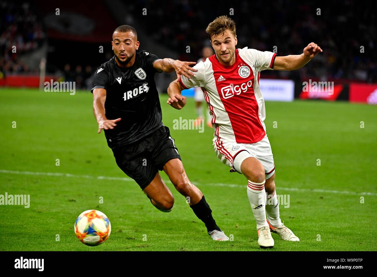 Joel Veltman (Ajax) duels Omar El Kaddouri during the UEFA Champions League third round qualifying second leg match between Ajax Amsterdam and PAOK FC at the Johan Cruijff Arena on August 13, 2019 in Amsterdam, The Netherlands Credit: Sander Chamid/SCS/AFLO/Alamy Live News Stock Photo