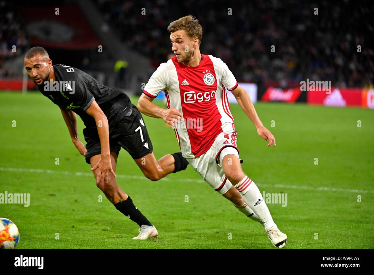 Joel Veltman (Ajax) duels Omar El Kaddouri during the UEFA Champions League third round qualifying second leg match between Ajax Amsterdam and PAOK FC at the Johan Cruijff Arena on August 13, 2019 in Amsterdam, The Netherlands Credit: Sander Chamid/SCS/AFLO/Alamy Live News Stock Photo