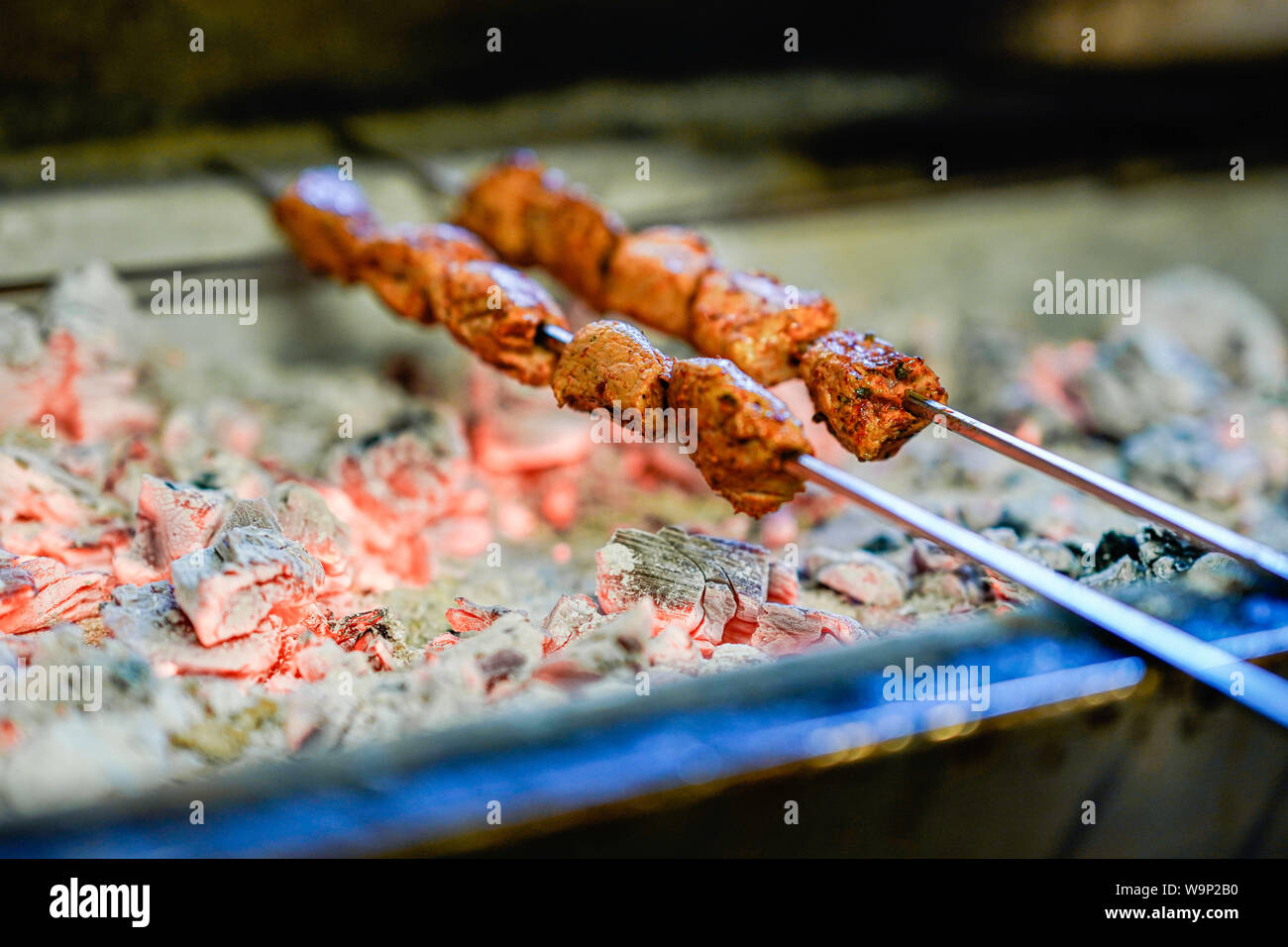 Mannheim, Germany. 13th Aug, 2019. Meat skewers are laid on a charcoal grill  in the Turkish