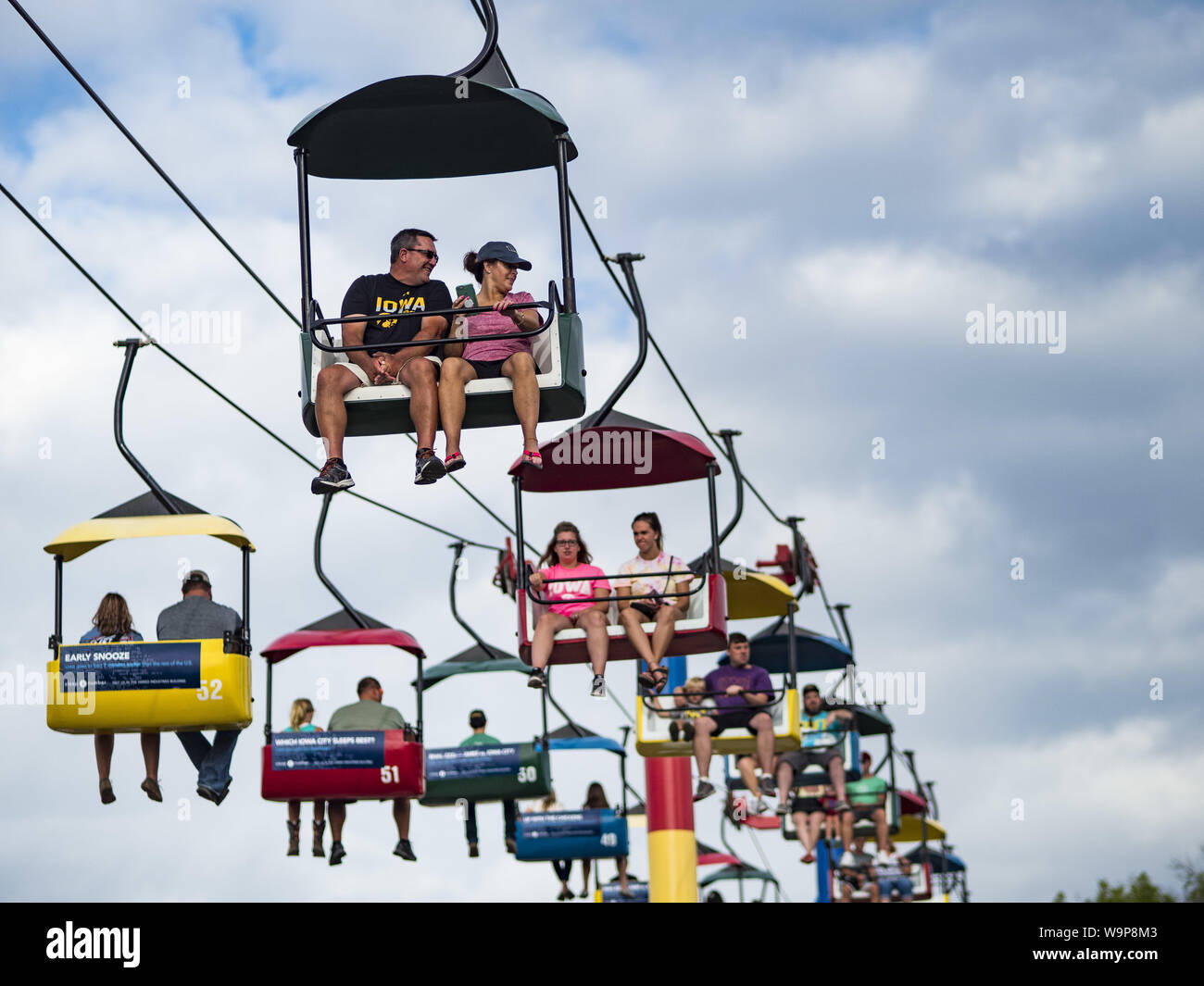 Des Moines, Iowa, USA. 14th Aug, 2019. People ride the Sky Glider above