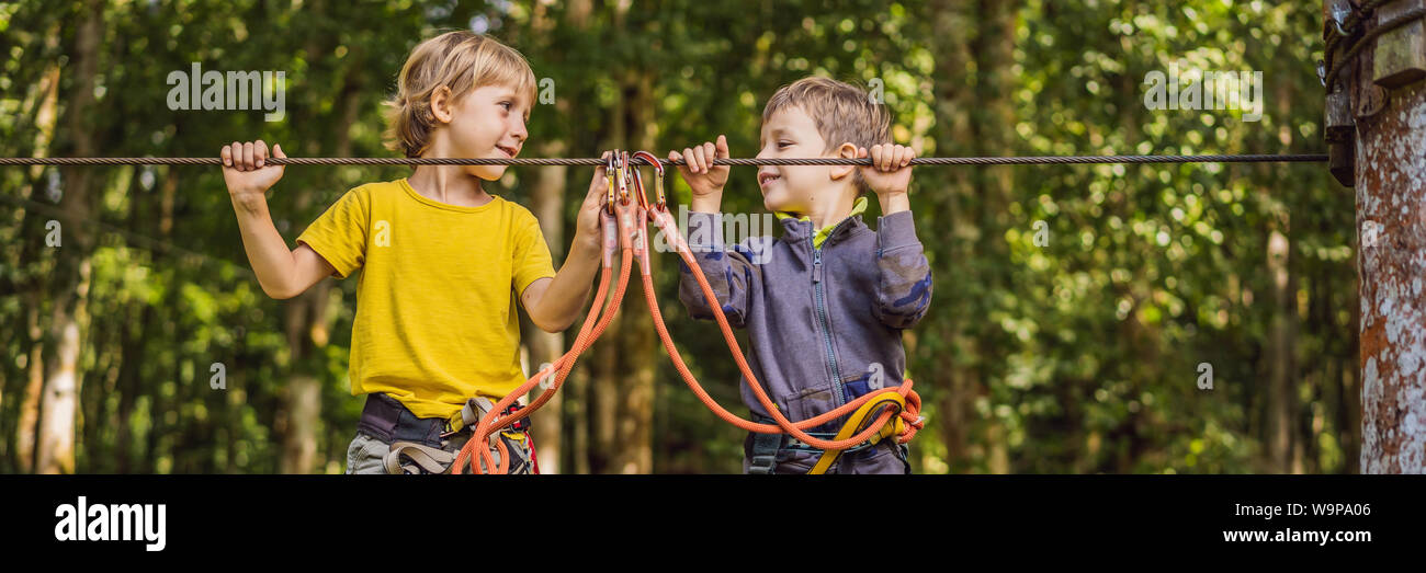 Two little boys in a rope park. Active physical recreation of the child ...