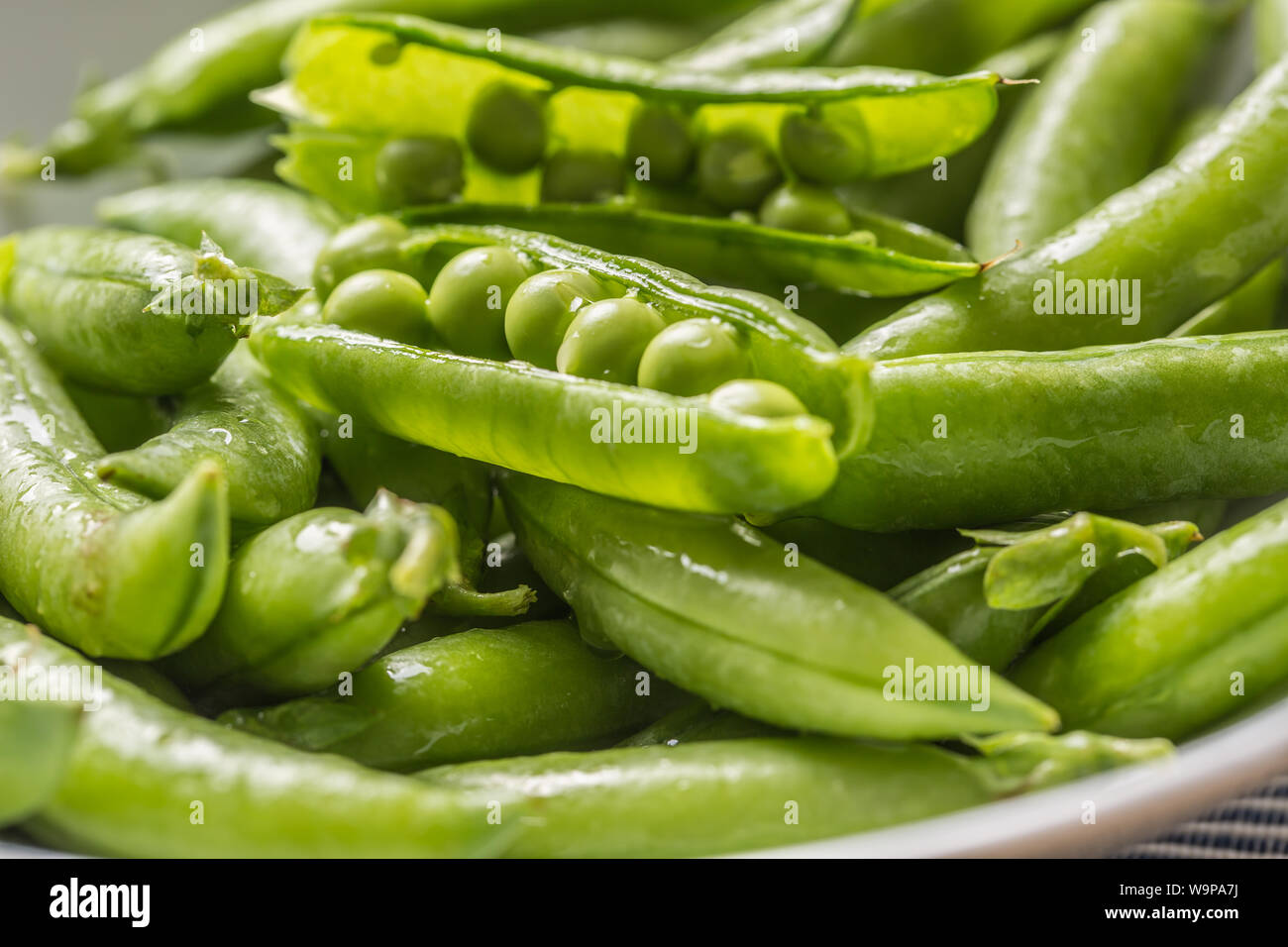 Fresh green pea seeds and pods - Close up Stock Photo