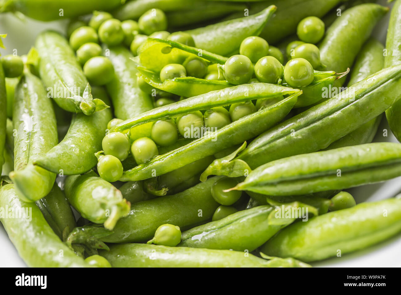 Fresh green pea seeds and pods - Close up Stock Photo
