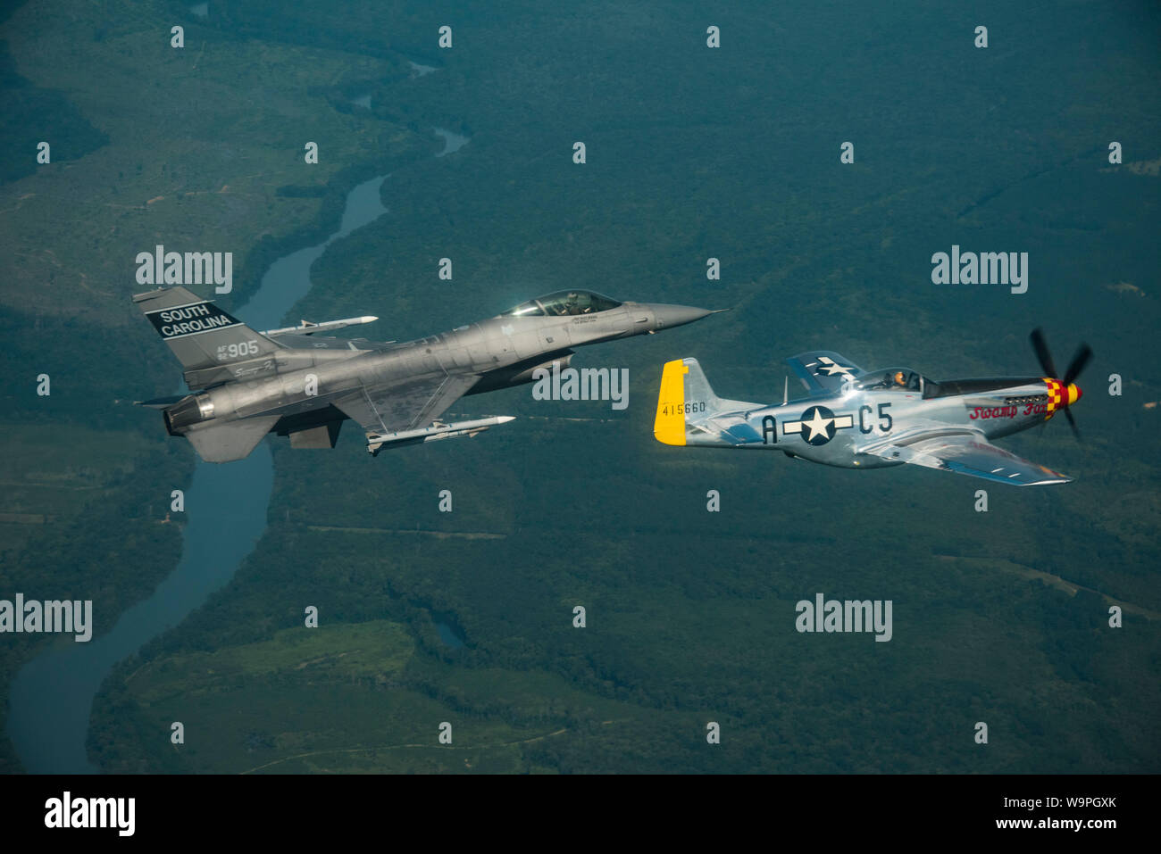 A South Carolina Air National Guard F-16 Fighting Falcon fighter jet, assigned to the 169th Fighter Wing, McEntire Joint National Guard Base, S.C. and a World War II era P-51 Mustang team up to celebrate their aviation history by flying together near South Carolina landmarks, Fort Sumter and USS Yorktown (CV 5), August 10, 2019. The 169 FW is proud of its 70-plus years as a single-seat fighter unit and its namesake, South Carolina American Revolutionary War hero General Francis “the Swamp Fox” Marion. The P-51 Mustang bears the name “Swamp Fox.” The P-51, owned and operated by R.T. Dickson, wa Stock Photo