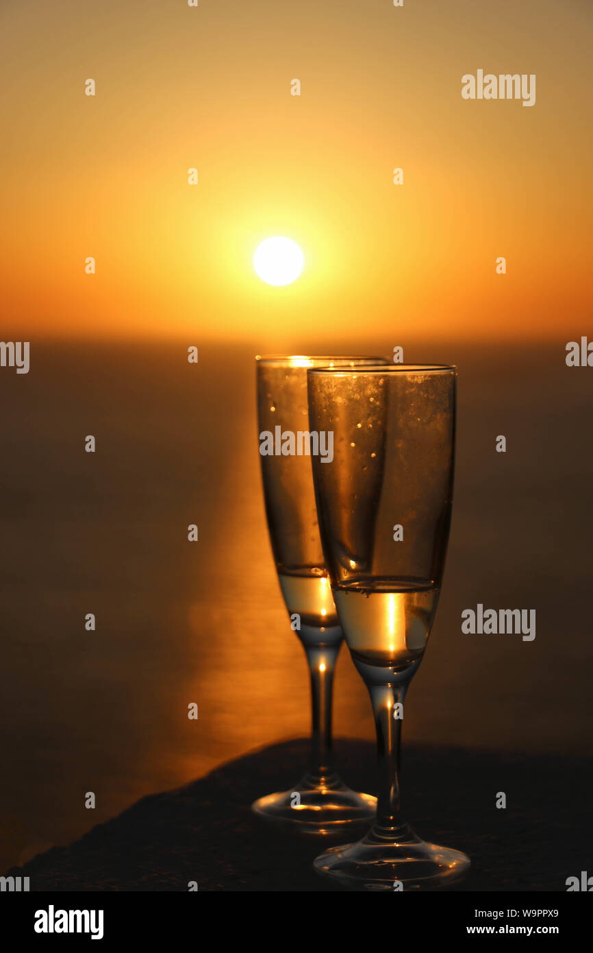 https://c8.alamy.com/comp/W9PPX9/two-glasses-of-champagne-overlooking-the-sea-at-sunset-W9PPX9.jpg