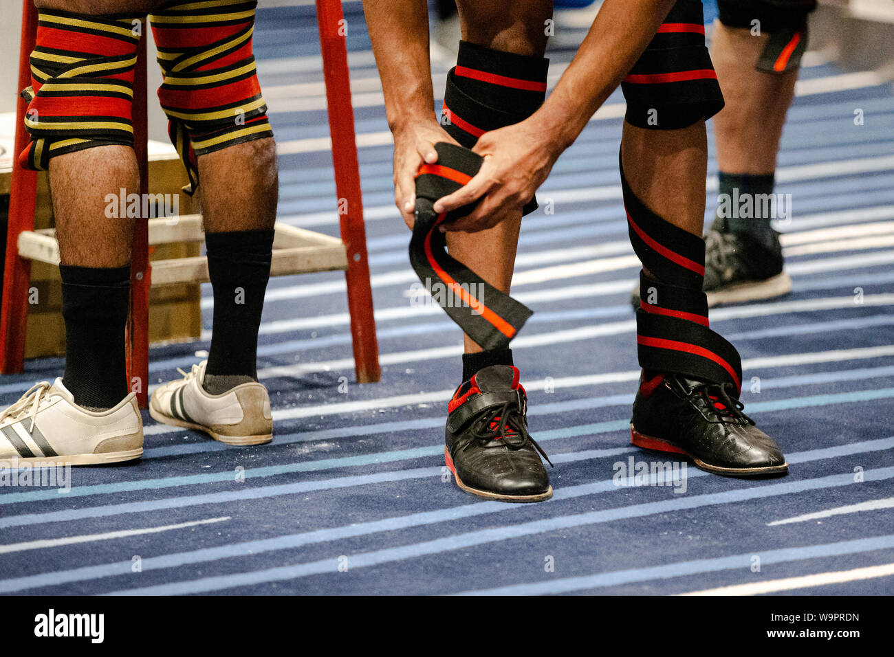 legs athlete powerlifter in knee wraps at powerlifting competition