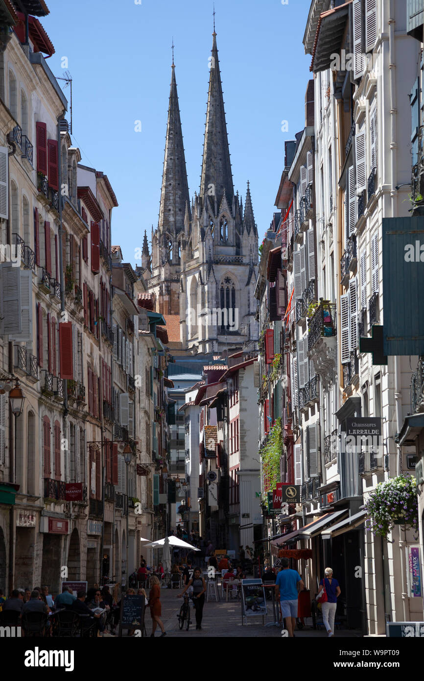 The view of the two steeples of the cathedral from the heart of the lower part of the old town of Bayonne. Stock Photo