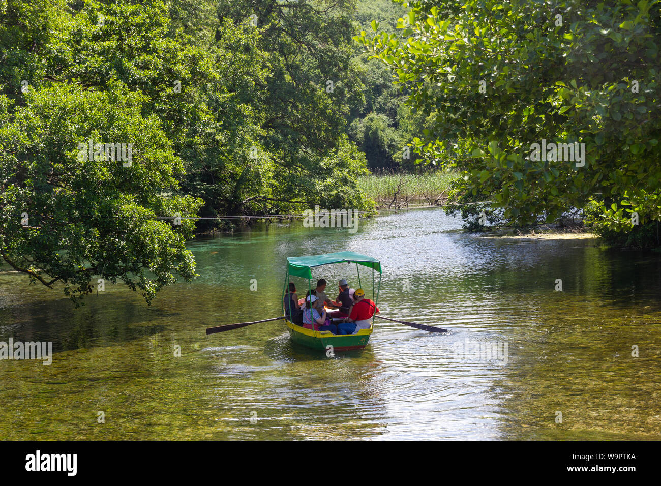 LJUBANISTA, MACEDONIA - MAY 29, 2018: Boat on the very clear river Black Drin at the monastery St Naum Stock Photo