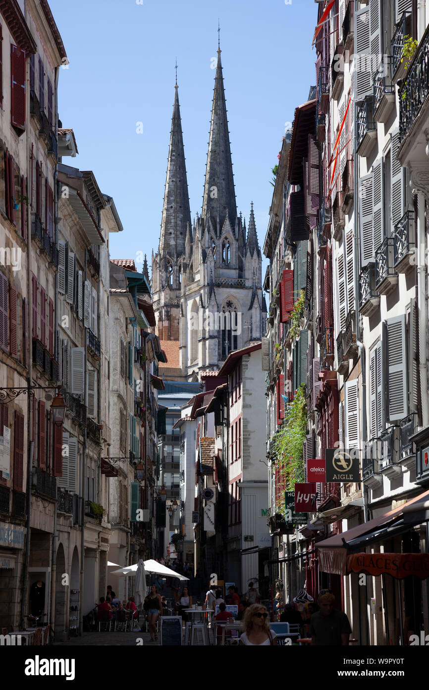 The view of the two steeples of the cathedral from the heart of the lower part of the old town of Bayonne (Atlantic Pyrenees - France). Stock Photo