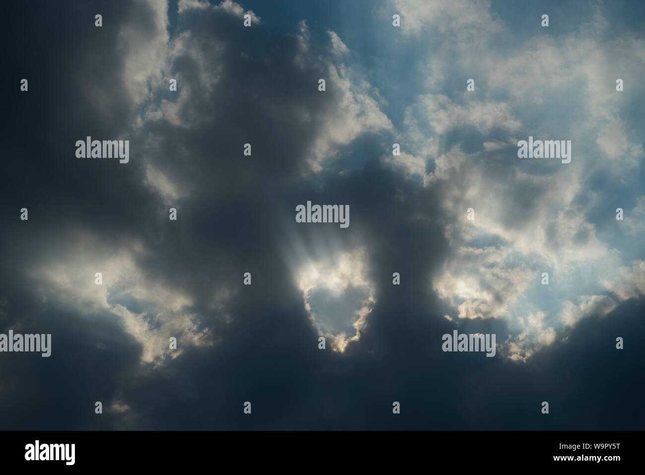 Weather Stormy, cloudy sky with a heartshaped opening, for background